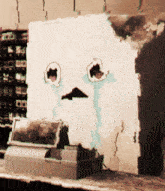 a cardboard box with a tear coming out of it 's eyes