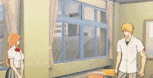 a man and a woman are standing in front of a window .