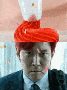 a man in a suit and tie with a red hat on his head