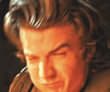 a close up of a man making a funny face