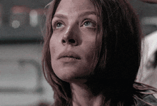 a close up of a woman 's face looking up at something