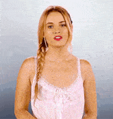 a woman wearing a braided hairstyle and a white tank top