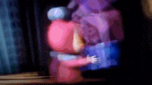 a blurry image of a person holding a blue box