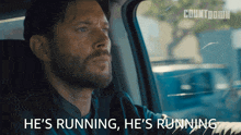 a man in a car with the words he 's running on the bottom