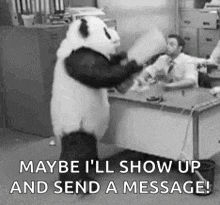 a panda bear is standing in front of a desk with a man in an office .