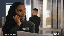 a woman wearing a chicago clinical center shirt is talking on a phone