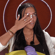 a woman covering her face with her hand while holding a purple bag that says ' ice do lines ' on it