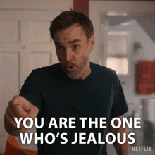 a man pointing at someone with the words " you are the one who 's jealous " on the bottom