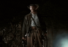 a man in a cowboy hat is standing in front of the word part