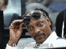 snoop dogg wearing sunglasses and a white shirt says damnn gene a