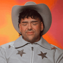 a man wearing a cowboy hat and a jacket with stars