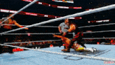 a wrestling match is being played in a stadium with a referee standing behind the ropes