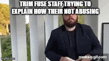 a man with a beard is standing in front of a window with a caption that says trim fuse staff trying to