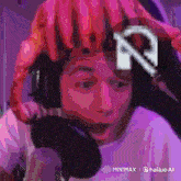 a person wearing headphones and a pink helmet with the letter r on top