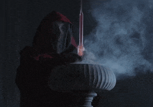 a man in a red hood is stirring something in a bowl