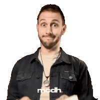 a man wearing a black jacket and a necklace with the word mcdh on it