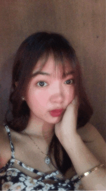 a girl with a necklace and a bracelet on her wrist