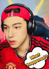 a man wearing headphones and a red shirt that says what happened on it