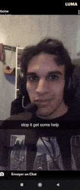 a man wearing headphones and a t-shirt with the word luma on it