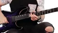 a man is playing a purple guitar with a sticker on the neck that says esp