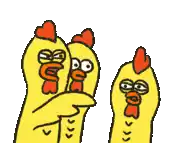 three yellow chickens are standing next to each other .