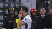 a soccer player wearing a white shirt that says gate.io on it