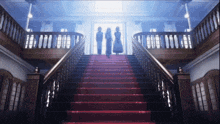 a group of people are standing on a set of stairs