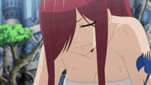 a woman with red hair has a tattoo on her arm