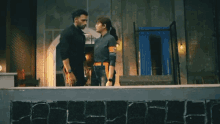 a man and a woman are standing next to each other and kissing in a room .