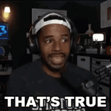 a man wearing headphones says that 's true in front of a microphone