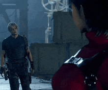 a man and a woman are standing next to each other in a dark room