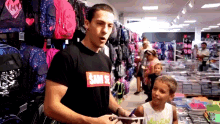 a man in a sam se shirt talks to a boy
