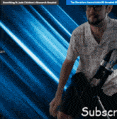 a man is holding a microphone in front of a blue background that says ' subscr ' on it