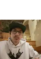 a man wearing glasses and a hat has a peace sign on his sweatshirt