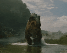 a large dinosaur is running through the water