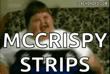 a man is sitting on a couch with the words `` mccrispy strips '' written on the screen .