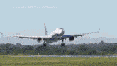 an airplane is taking off from a grassy field