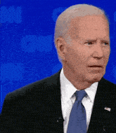 a man in a suit and tie is standing in front of a cnn background