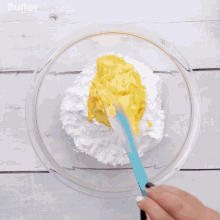 a person is using a mixer to mix ingredients in a bowl that says butter on the bottom