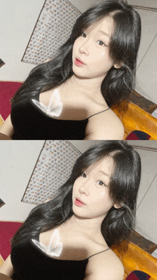 a woman with long black hair is wearing a black top