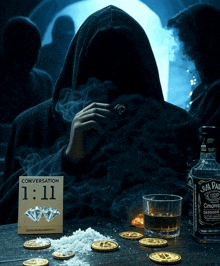 a bottle of jack daniels sits on a table next to a man in a hood