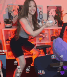 a woman is dancing in front of a shelf that says 8/800 on it