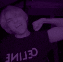 a man is wearing a purple shirt that says celine