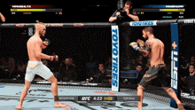two fighters are fighting in a cage with a toyo tires sign in the background