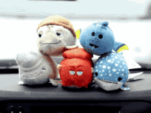 a group of stuffed animals sitting on a dashboard