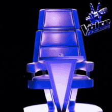 a blue chair with the words the voice academy written on it