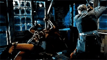 two men are fighting in a dark room with a window