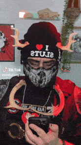 a man wearing a mask and a beanie that says i 2tu2