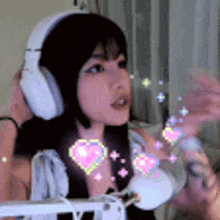 a woman wearing headphones with hearts on her face .