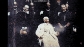 a black and white photo of a man sitting in front of a group of men with the words www.bandicam.com visible